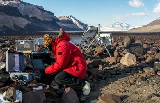 Earth scientist Jennifer Lamp adjusts some of the acoustic monitoring equipment she set up in Beacon Valley.
