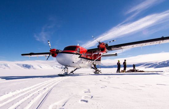 A Twin Otter aircraft, owned and operated by Kenn Borek Air, on a glacier in the Transantarctic Mountains.
