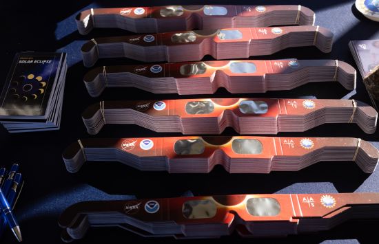 A collection of special eclipse sunglasses on a table