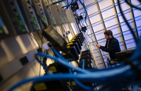 Applications Programmer Jesse Wolf ’22 sets up edge computers — more than 2,000 of these nodes allow researchers to deploy and test algorithms.