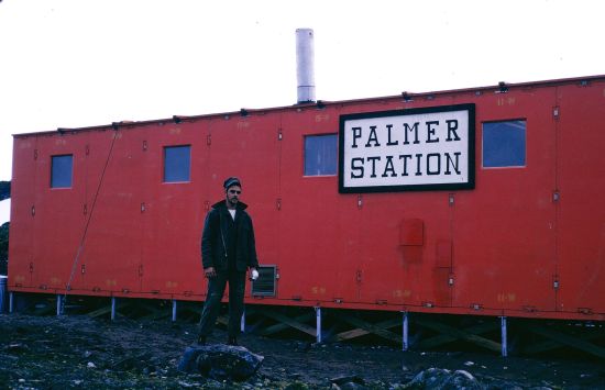 U.S. Navy Seabee Chuck Alletto stands in front of a newly constructed building at what is now known as Old Palmer Station.
