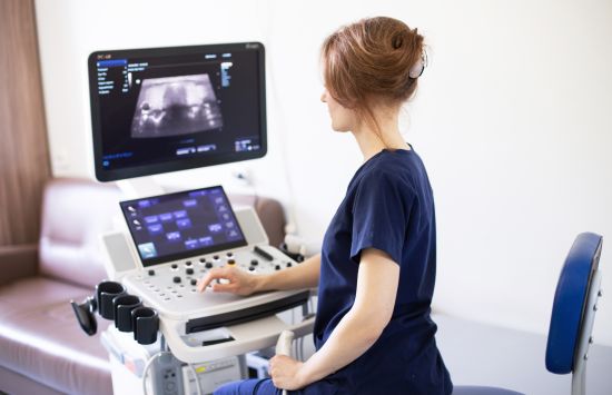 A medical professional uses an ultrasound machine.