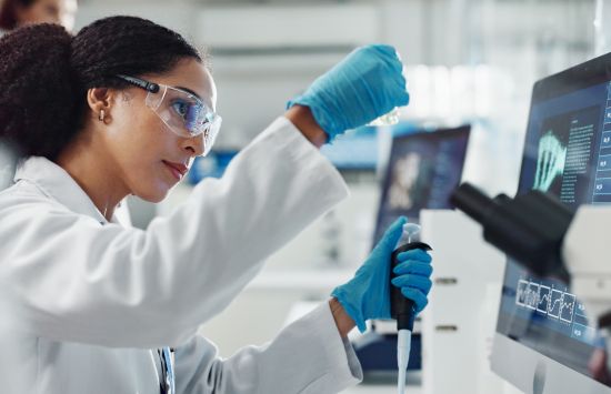 A researcher examines a sample in a pharmaceutical lab.