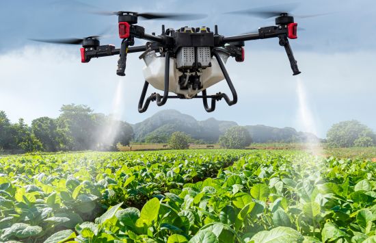An industrial drone treats crops with an antibacterial spray.