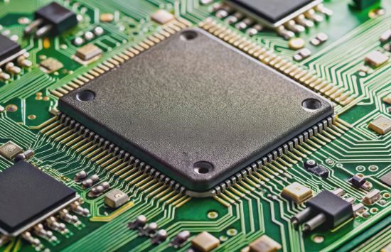 A flattened black square on a green background, surrounded by smaller black squares and golden stripes. 