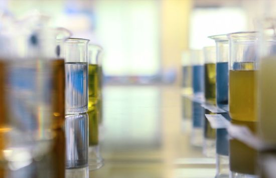 A close-up of beakers with different-colored liquids in them.