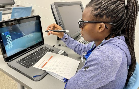 High school student using virtual reality at a laptop