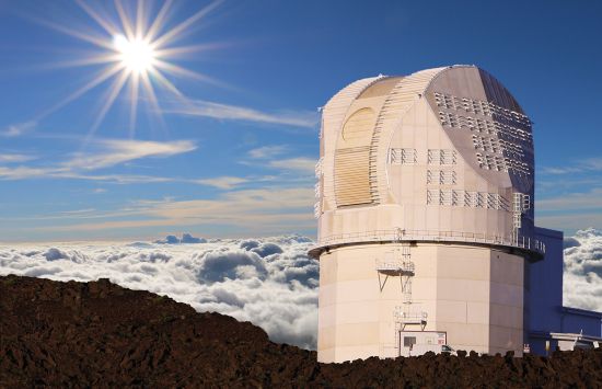 A large telescope facility on the summit of a mountain above the clouds.