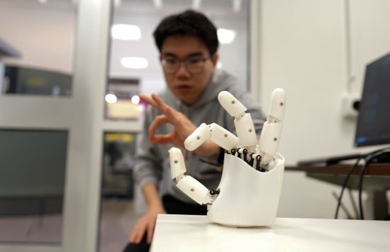 MIT graduate student Dian Li demonstrating an innovative ultrasound-based human-robot control interface