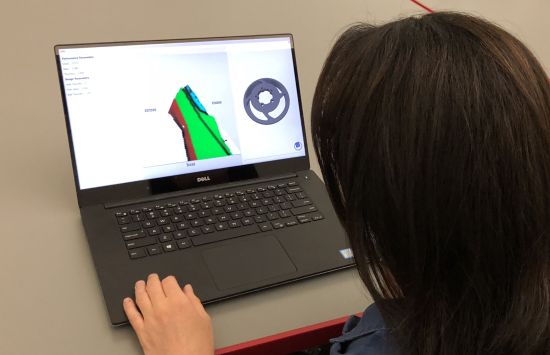 A person uses CAD software on their laptop.