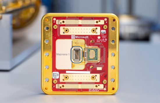 A gold and red rectangular computer chip with many small wires and other electronic components.