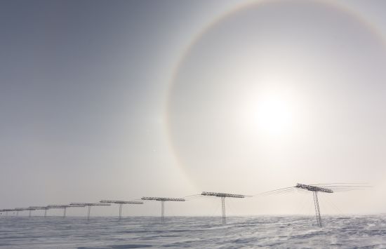 A halo around the sun, caused by sunlight refracting through ice particles in the atmosphere, seen over the SuperDARN Array. The experiment is part of a radar system that monitors the auroras in the Ionosphere over Earth's polar regions