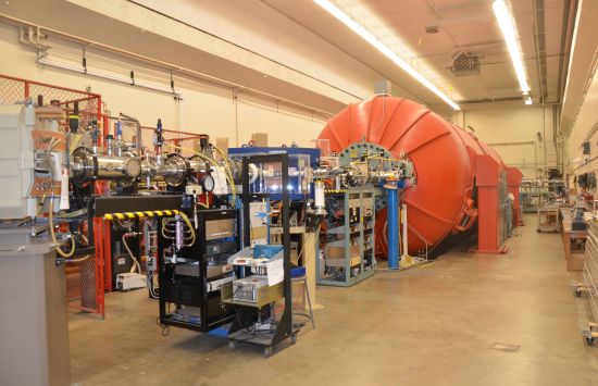 A large room with various equipment including a huge orange tank.