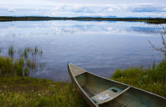 A canoe sits next to Salmonberry Lake in Nikolai, Alaska.
