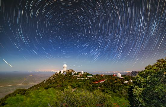 Star trails circle and illuminate the night sky in this long-exposure photo of Kitt Peak National Observatory.