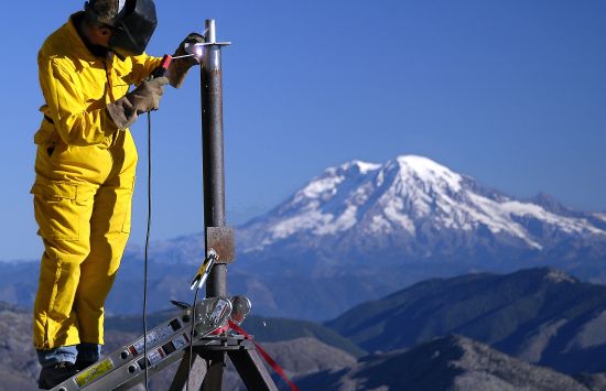 Peter Gray, an engineer with the nonprofit research consortium UNAVCO, welds one of five global positioning system (GPS) stations on the flanks of Mount St. Helens in Washington state.