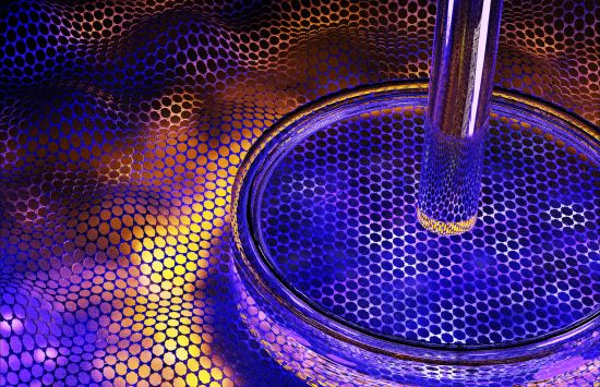 A glass dish and rod sitting on a material that looks like a rippled mesh with hexagonal holes in it and purple, blue and yellow light glowing through it from below.