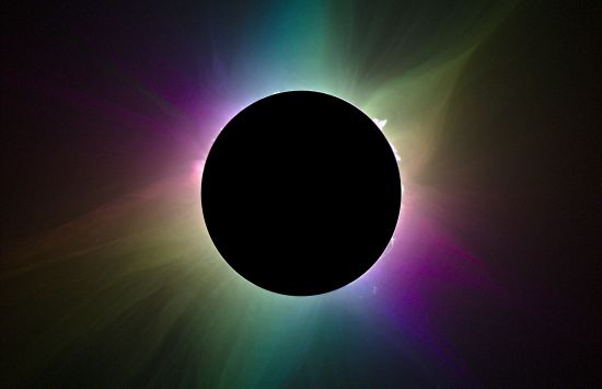 The moon casts a shadow in front of the sun during a total eclipse.