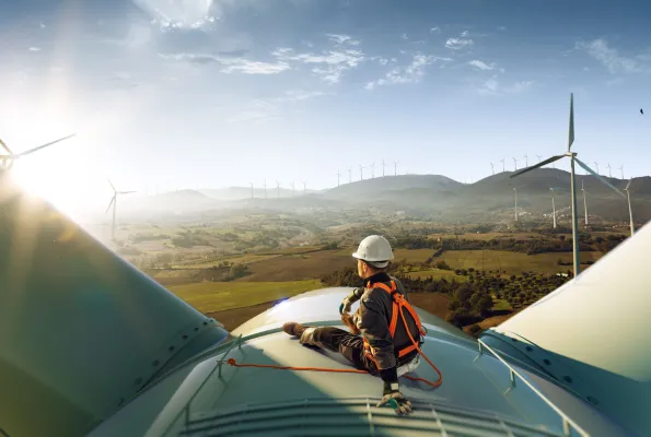 Worker on top of wind turbine