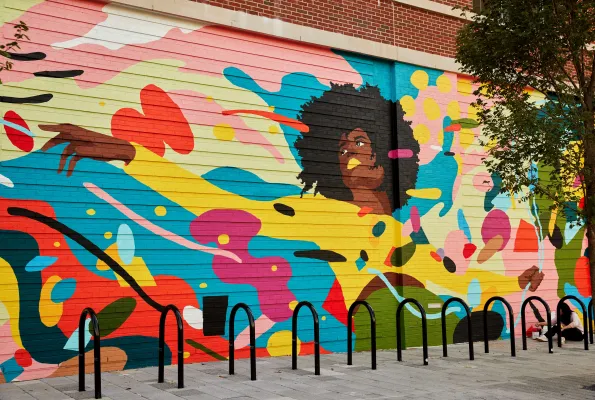 A mural of a woman surrounded by colorful shapes