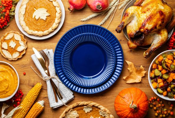 a photo of a plate surrounded by a turkey, pie, a fork
