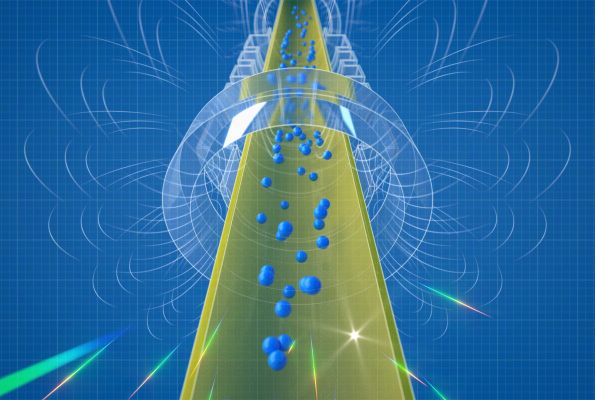 Small blue spheres representing antihydrogen atoms fall downward through a cylindrical apparatus.