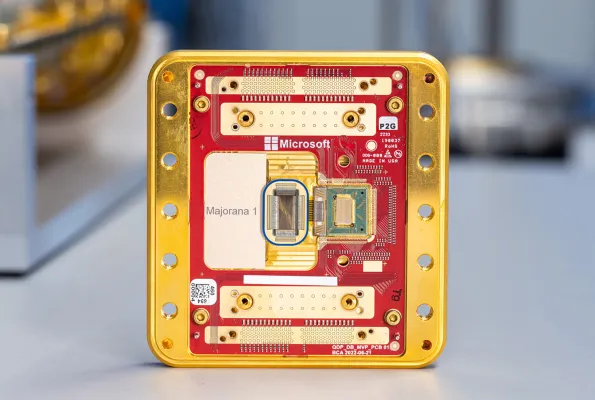 A gold and red rectangular computer chip with many small wires and other electronic components.