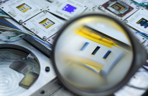 Magnifying glass held up to solar cell components