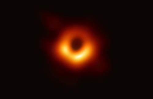 An image of a black hole at the center of galaxy M87*, outlined by emission from hot gas swirling around it under the influence of strong gravity near its event horizon.