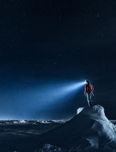 Man on arctic hill at night