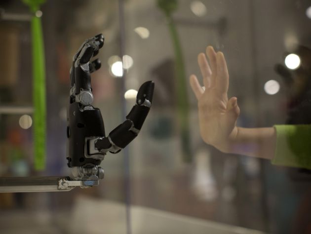 robot hand and human hand mirroring each other