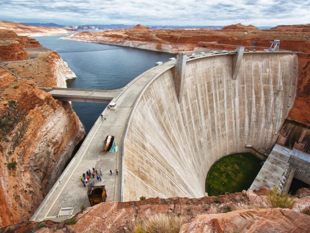 a large concrete dam sits in the middle of a river
