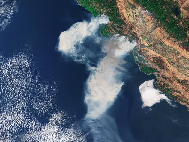 A satellite image shows smoke from a wildfire above the northern California coast