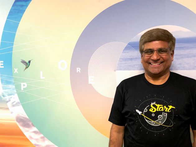 Man standing in front of colorful mural
