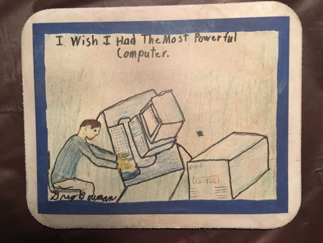 A child's drawing depicts a man sitting at a computer with the the title "I wish I had the most powerful computer"