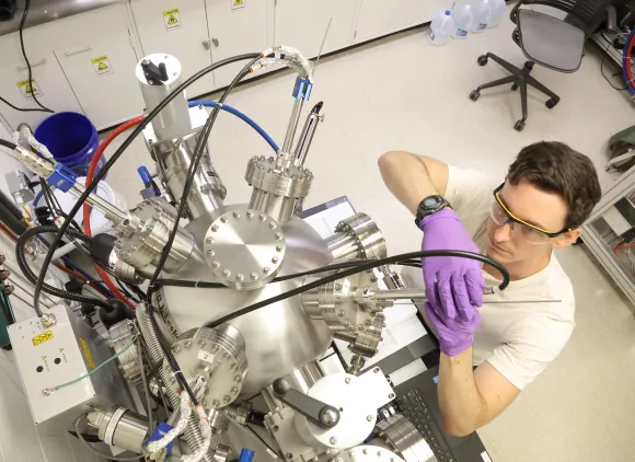 A student adjusts a piece of laboratory equipment