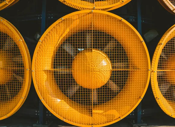 Close-up of a giant, human-sized fan.