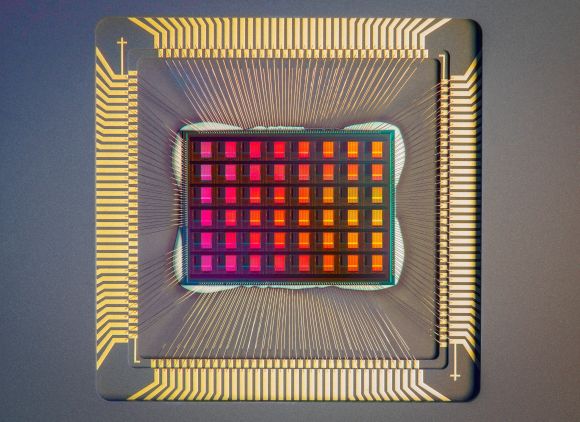 A closeup of a computer chip, featuring a red grid surrounded by golden bands