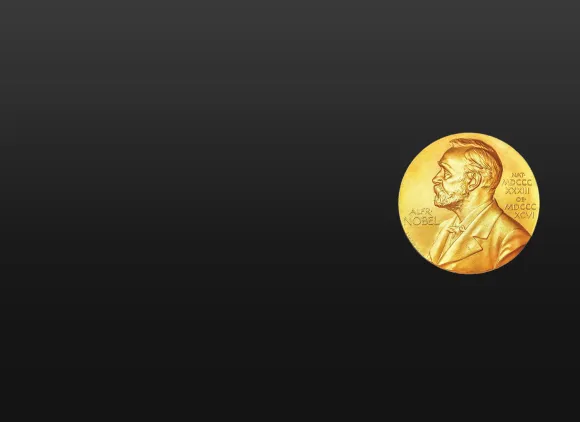The circular, golden Nobel Prize medal, featuring a portrait of Alfred Nobel, against a black background.