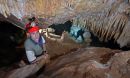 man with red hard hat in a cave