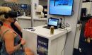 A woman explores NSF's Ice Cube through a virtual reality headset at an NSF event booth