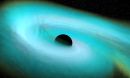 A black sphere orbited by a glowing, bluish swirl, against a black background.