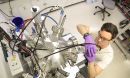 A student adjusts a piece of laboratory equipment