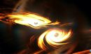 Image of two black holes merging. Gravitational waves can be seen between the two.