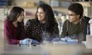 A professor in a lab with two students