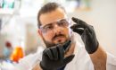 Researcher observes saliva sample from a ferret