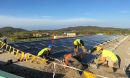 Madison College graduate Mike Reuter (in blue helmet) leads a solar panel installation crew for a renewable energy program