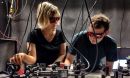 Two researchers wearing protective eyewear stand at a laboratory set-up