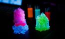 Brightly colored glowing 3D-printed objects on a black background.