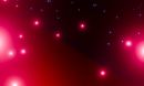 Red and blue particles against a dark background.